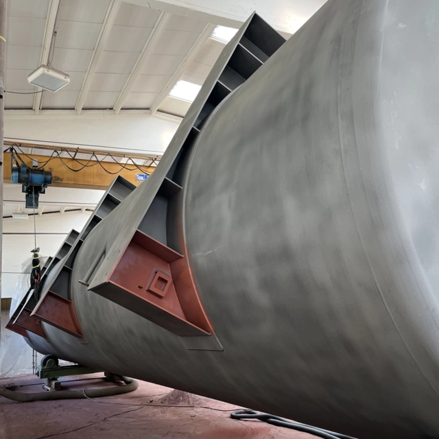 Surface preparation phase via abrasive blasting.